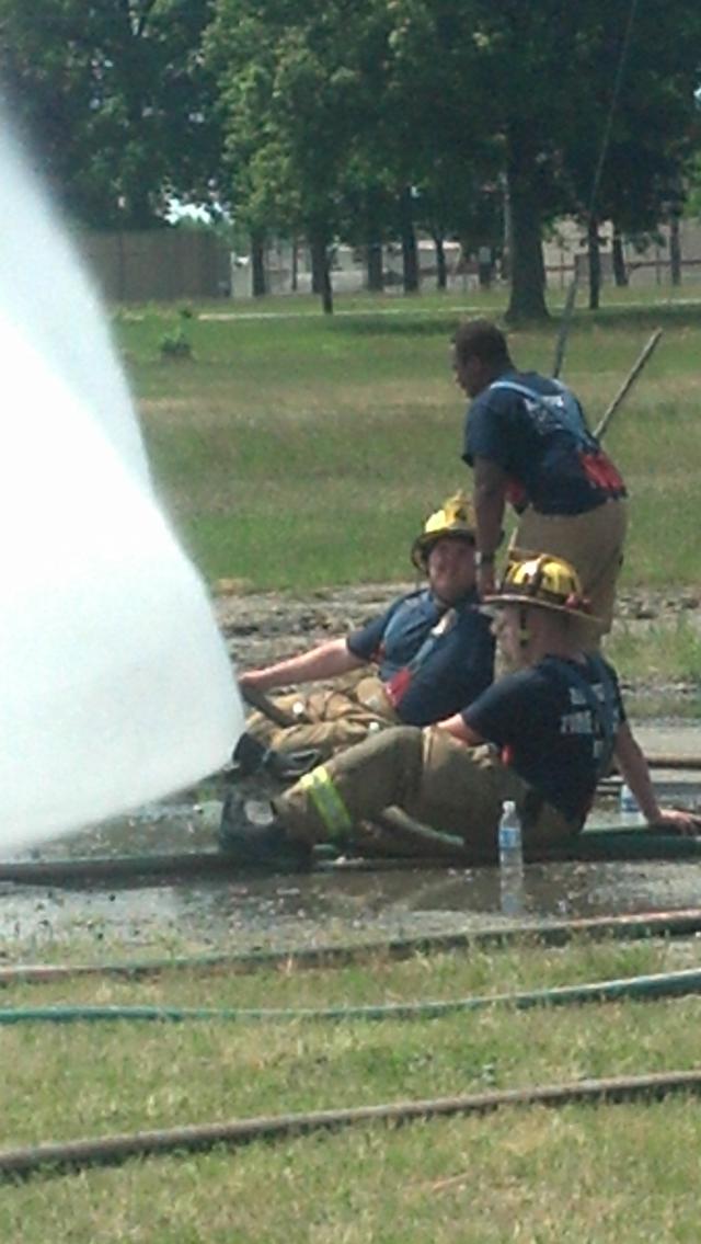 Firefighters use fog patterns to help reduce the radiant heat from the fully-involved building.