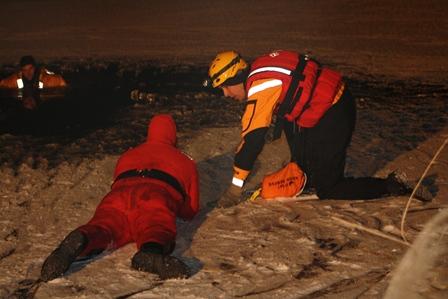 Crews learning and practicing ice rescue strategies and tactics.