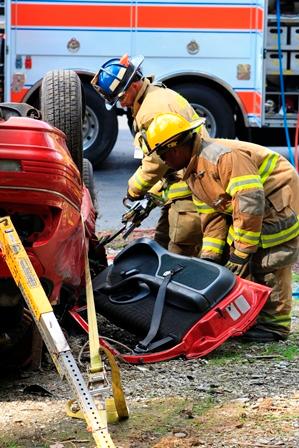 Firefighters remove a door during a vehicle extrication drill at a recent Open House.